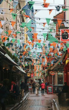 street with multicolored fiesta flags during daytime