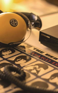 a pair of headphones sitting on top of a record player